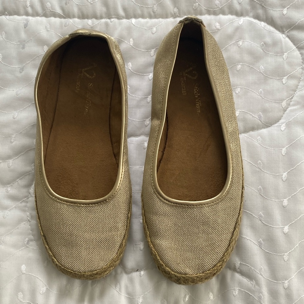 Gold metallic flats with rope like sides.